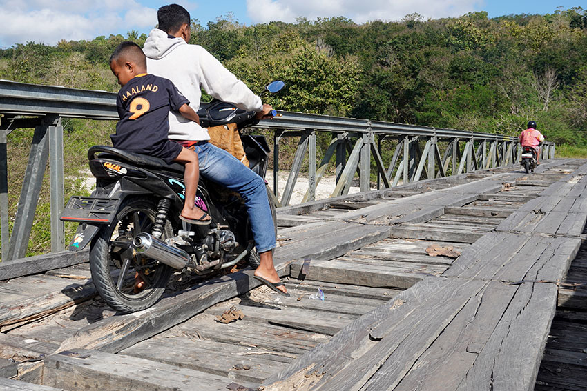 Warga melintas di Jembatan Kayu Neobunu, di Desa Oeekam, Kabupaten Timor Tengah Selatan, NTT, Jumat (25/7). [astakom/str-Axel Olivier]
